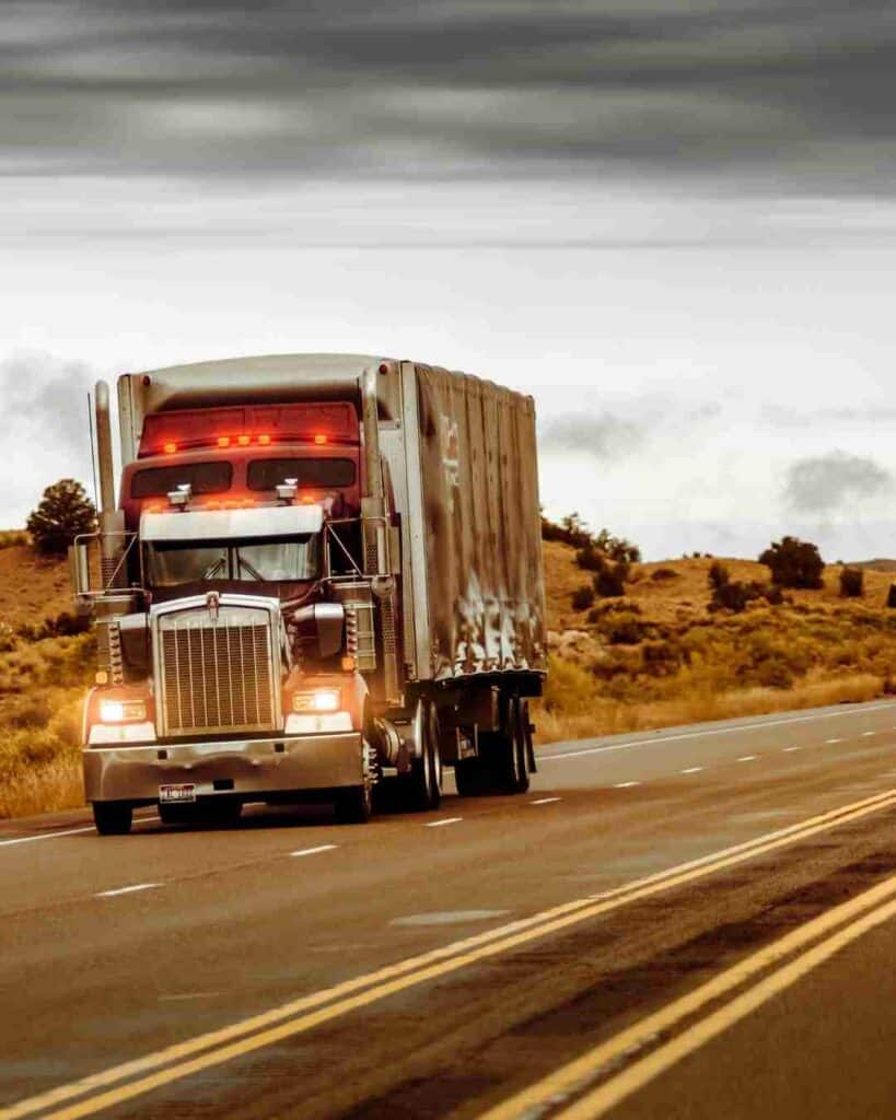 Large semi-truck transporting cargo on a highway.