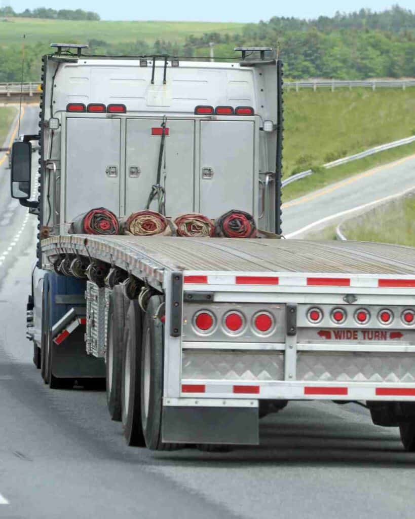 Large commercial truck driving on highway in Texas.