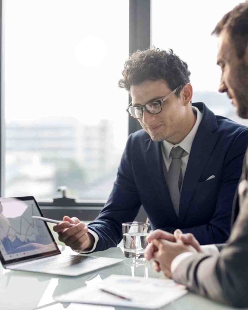 Business professionals discussing insurance options in an office setting.